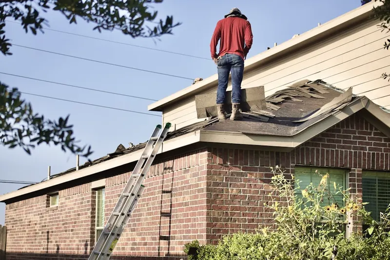 Professional roofer working on a residential roof in Hartwell